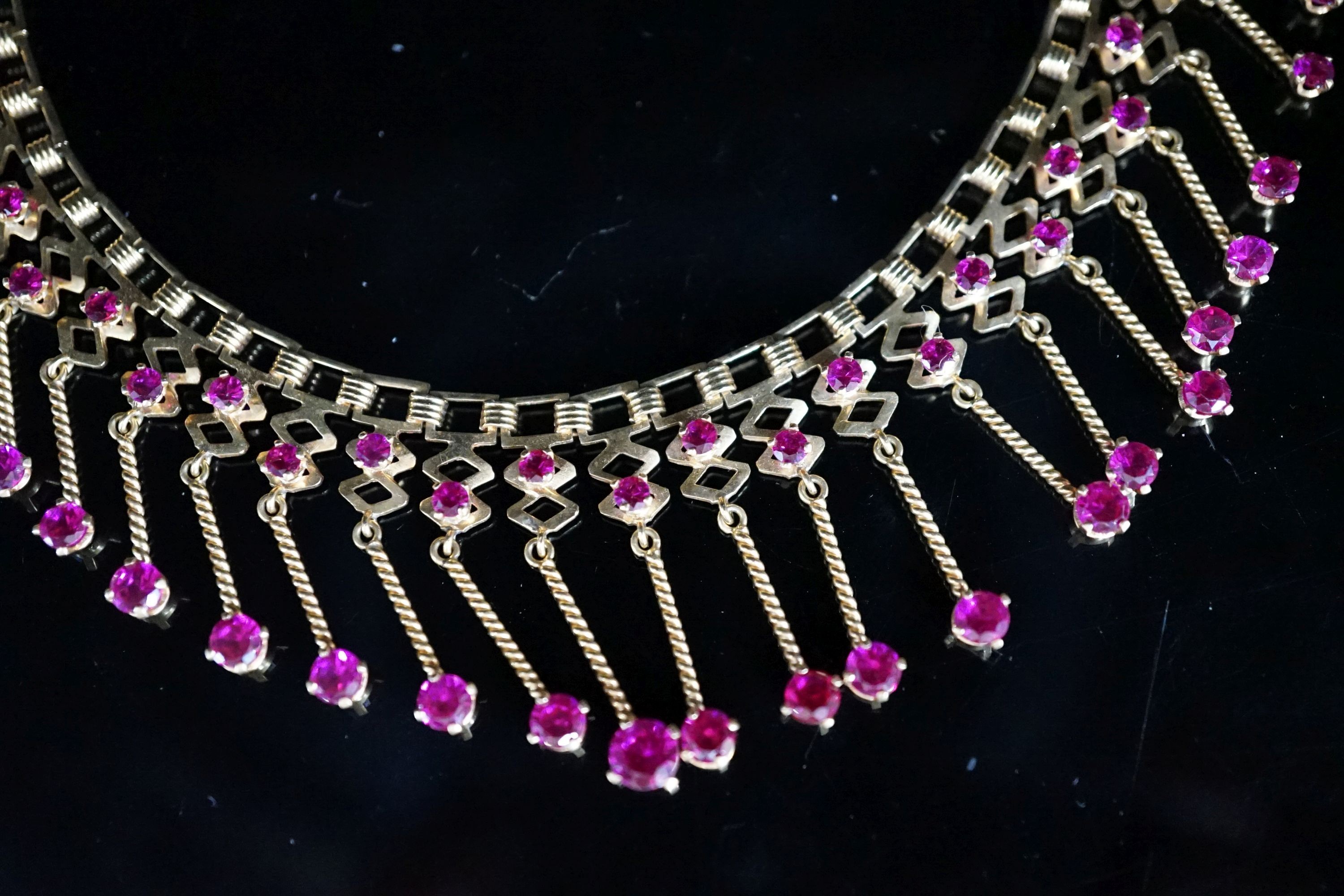 A modern yellow metal (stamped 18) and synthetic ruby? set drop fringe necklace, 41cm, gross 35 grams.